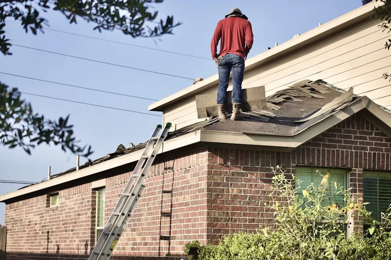 Professional roofer working on a residential roof in Ivy Falls